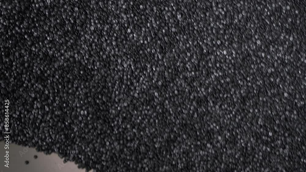 Processing black plastic granules for recycling at the compounding plant. Industrial equipment repurposing plastic waste into black granules. Manufacturing huge amounts of black plastic granules. Processing black plastic granules for recycling at the compounding plant. Industrial equipment repurposing plastic waste into black granules. Manufacturing huge amounts of black plastic granules.