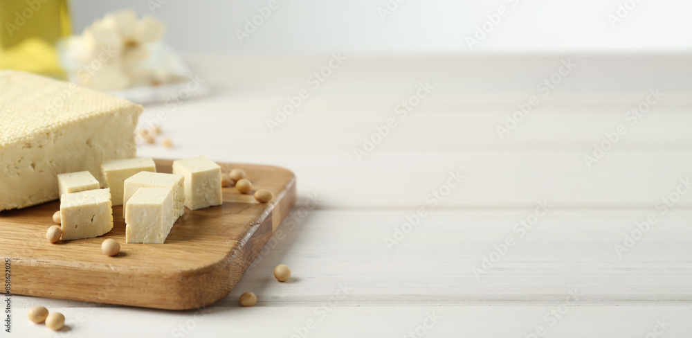 Delicious tofu and soybeans on white wooden table, space for text. Banner design Delicious tofu and soybeans on white wooden table, space for text. Banner design