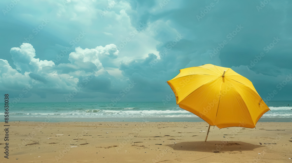 yellow beach umbrella against dramatic storm clouds at seaside