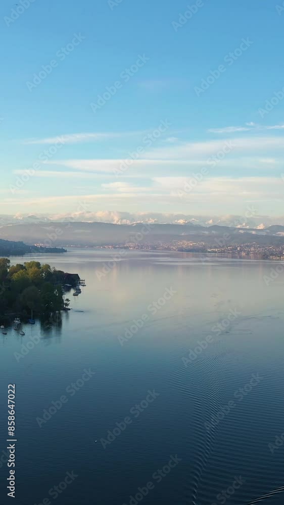 Zurich Lake and Swiss Alps on Sunny Morning. Snow-Capped Mountains. Switzerland. Aerial View. Drone Moves Forward. Vertical Video Zurich Lake and Swiss Alps on Sunny Morning. Snow-Capped Mountains. Switzerland. Aerial View. Drone Moves Forward. Vertical Video