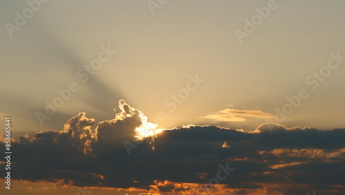 View of the sunset with light spilling through the gaps in the clouds (copy space) photo