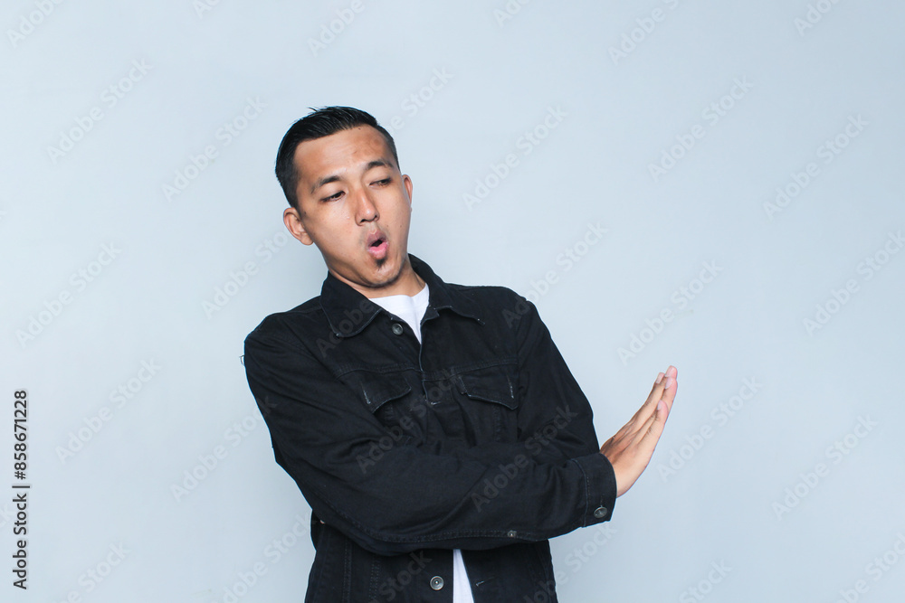 Concerned Indonesian Asian Man showing refusal sign, saying no, raise awarness, standing on the white background.	