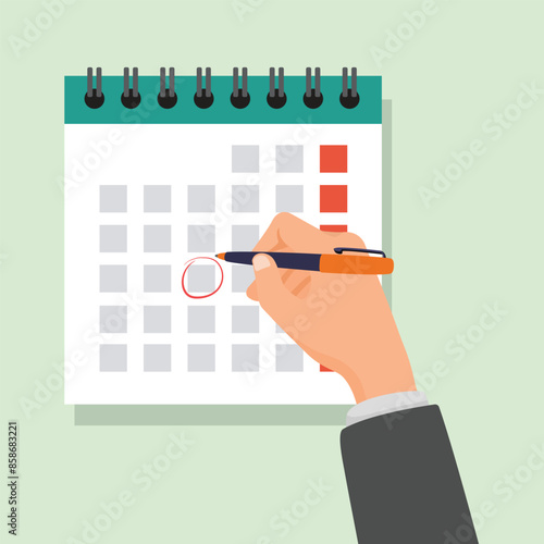 Businessman hand making mark on calendar