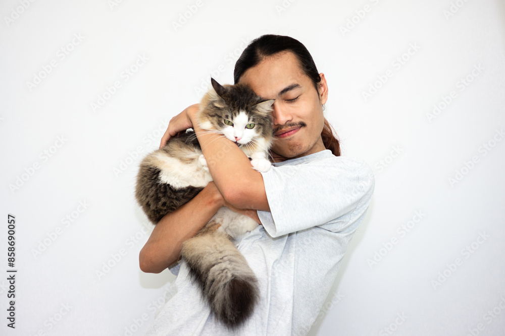 smiling young man with a black and white cat in his arms. isolated in white background smiling young man with a black and white cat in his arms. isolated in white background