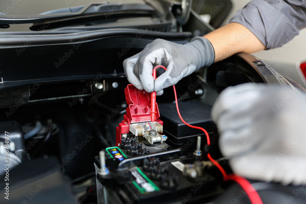 Close-up hand auto mechanic using meter to check car battery fail problem for service or change repairing and fix car and maintenance servicing. Close-up hand auto mechanic using meter to check car battery fail problem for service or change repairing and fix car and maintenance servicing.