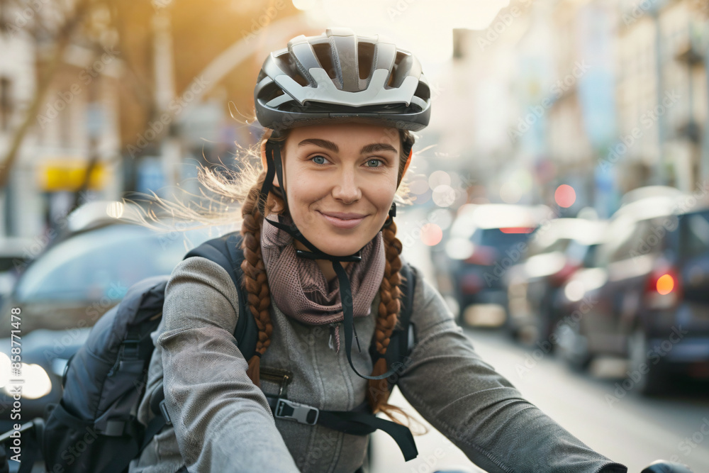 a woman riding a bike down a street a woman riding a bike down a street