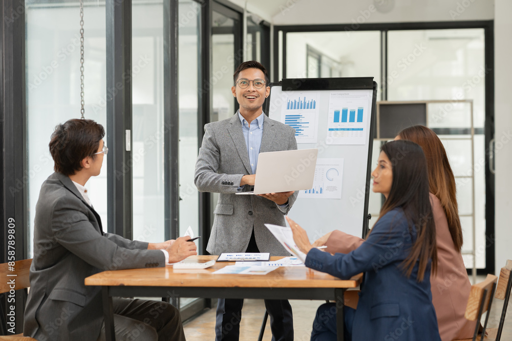 Asian Business Group Chat about graph work Present in meetings, in the office Asian Business Group Chat about graph work Present in meetings, in the office