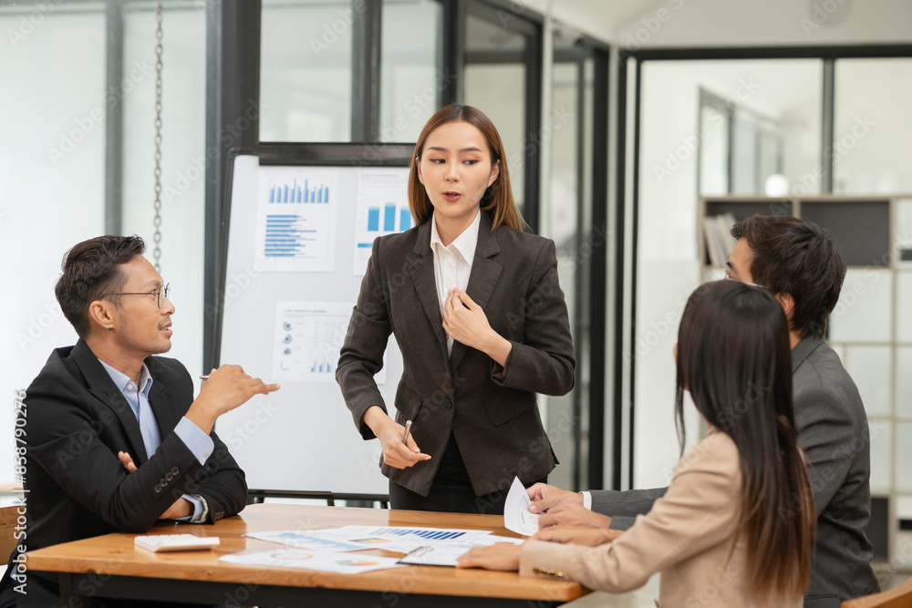 Asian Business Group Chat about graph work Present in meetings, in the office Asian Business Group Chat about graph work Present in meetings, in the office