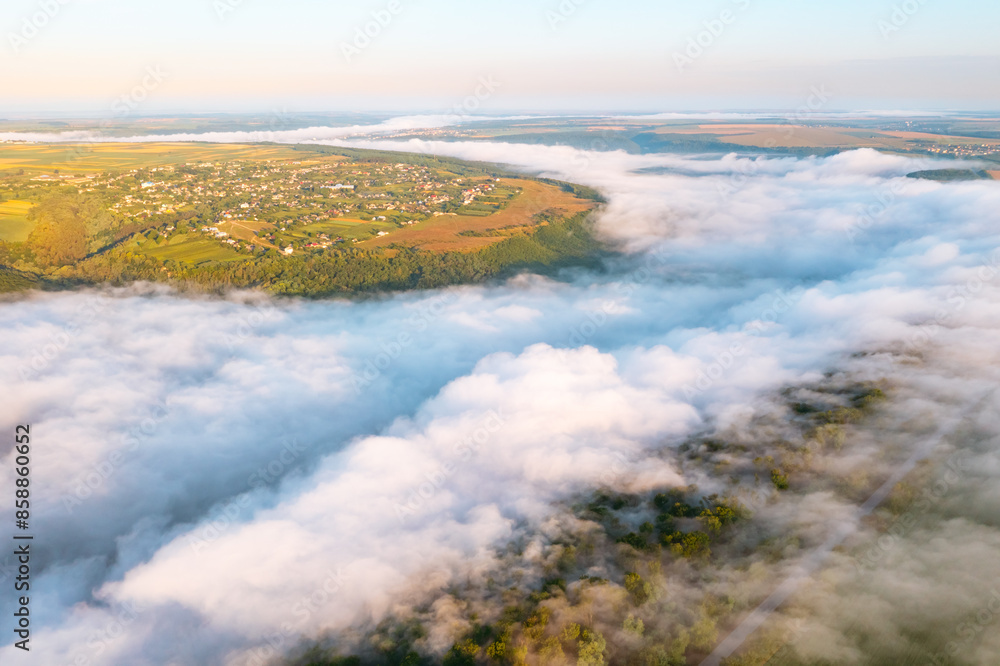 A gorgeous bird's eye view of the valley covered with thick fog. A gorgeous bird's eye view of the valley covered with thick fog.