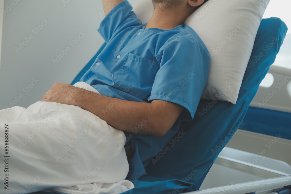 Obraz premium Seriously Ill Man Lying on a Bed in the Hospital. Monitors Show His Vital Signs. Ward is Clean and New.