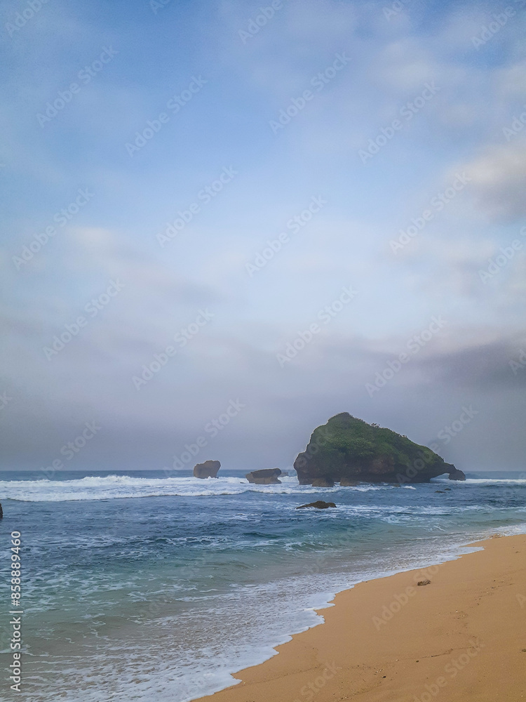 Secluded Shoreline Grandeur: A Pristine Sandy Beach With a Majestic Rock Formation Standing Tall Against the Horizon Secluded Shoreline Grandeur: A Pristine Sandy Beach With a Majestic Rock Formation Standing Tall Against the Horizon