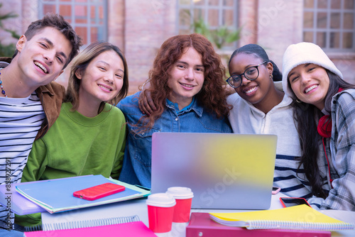  Group of students, prepare for university exams, use a laptop looking at camera