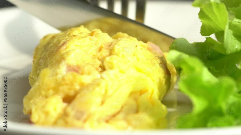 A plate of food with a yellow omelet and a green leafy vegetable. The plate is white and the food is arranged neatly A plate of food with a yellow omelet and a green leafy vegetable. The plate is white and the food is arranged neatly