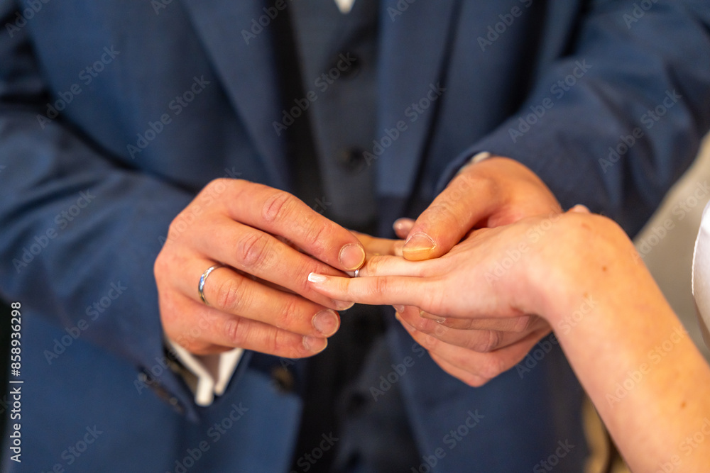 A man and woman are getting married, with the man holding a ring