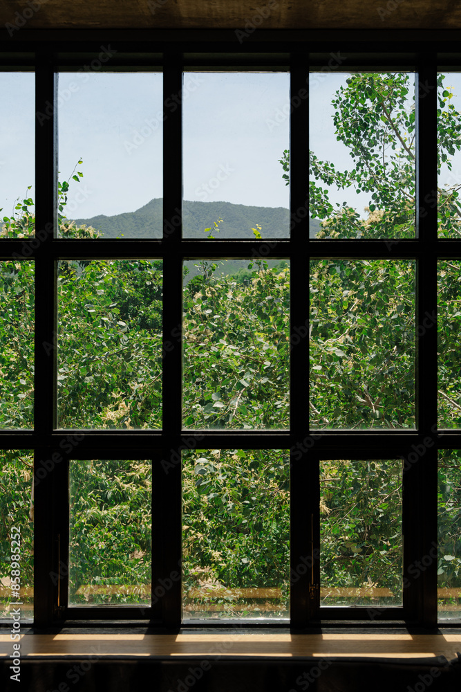 Scenic View through Large Window with Greenery and Mountains Scenic View through Large Window with Greenery and Mountains