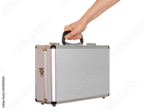 A woman's hand holds a small aluminum suitcase isolated on a white background