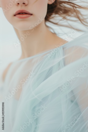 young woman wearing a flowing, pastel blue dress, ethereal, minimalist, serene, soft blues