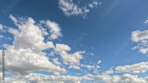 Timelapse of white clouds in blue sky moving fast
