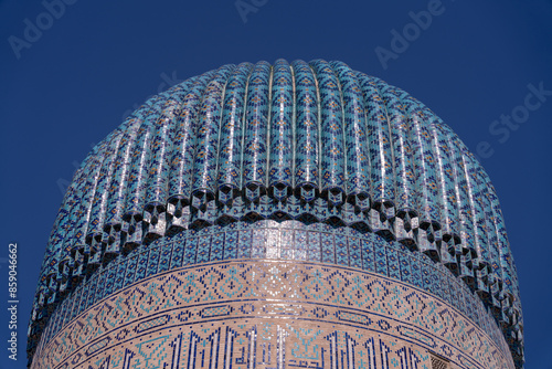 A blue dome with a blue and white pattern. The dome is on top of a building photo