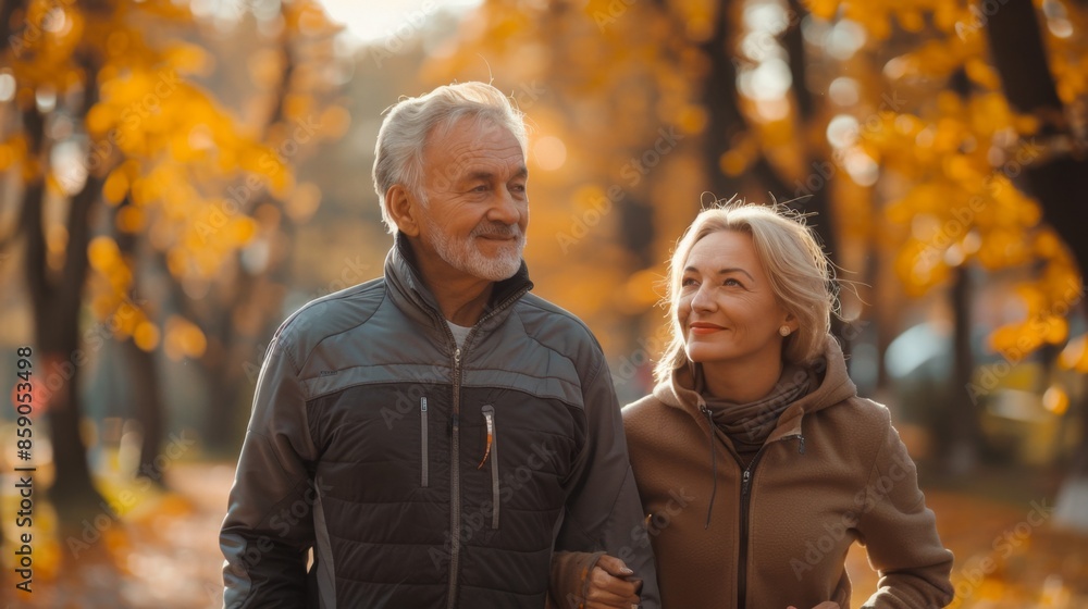 cheerful happy couple of caucasian pensioners, mature man and woman walking in park in autumn together cheerful happy couple of caucasian pensioners, mature man and woman walking in park in autumn together