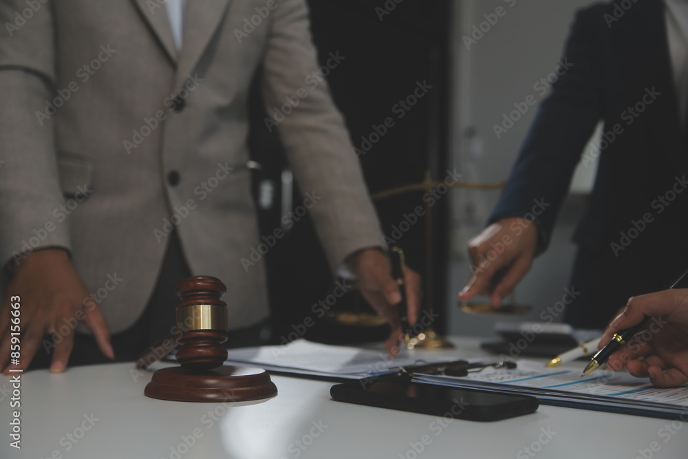 Judge gavel with Justice lawyers having team meeting at law firm background. Concepts of Law and Legal services. Judge gavel with Justice lawyers having team meeting at law firm background. Concepts of Law and Legal services.