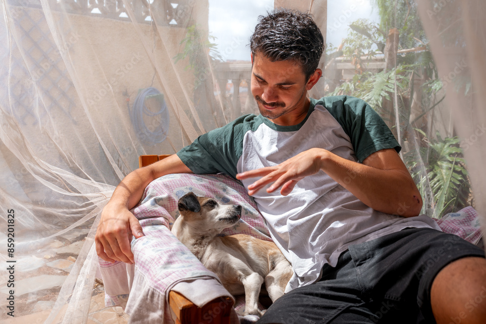 young man interacts with a common dog in a garden young man interacts with a common dog in a garden