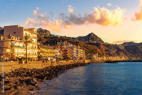 Fototapeta Naklejka Na Ścianę i Meble -  morning sunrise landscape on a city emnarkment with beach and sea coast and beautiful mediterranean street with buildings