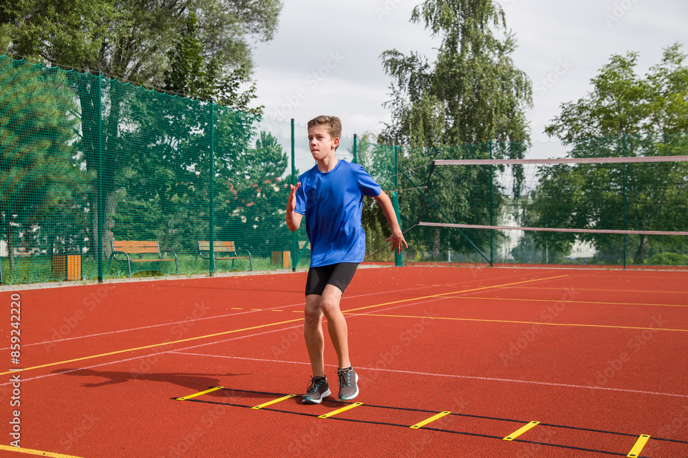 Fototapeta premium An athlete does special running exercises on a ladder.