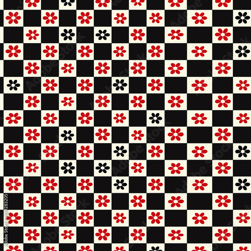 a close up of a checkered pattern with red and black flowers