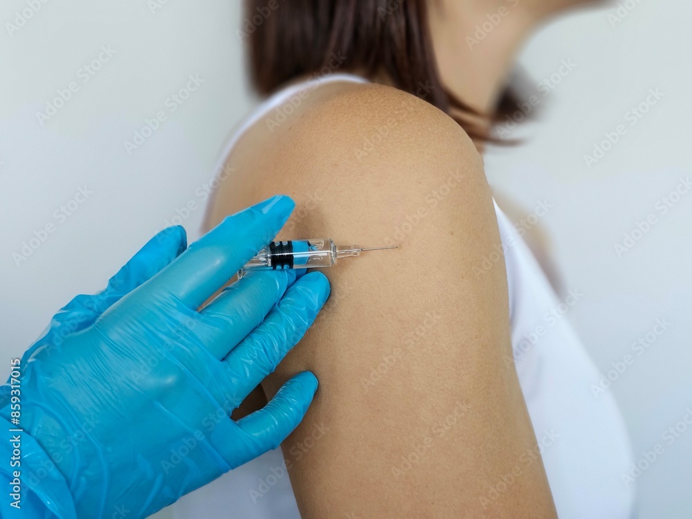 © Nadzeya - A Close Up Of A Person Receiving A Vaccine Injection In Their Shoulder © Nadzeya - A Close Up Of A Person Receiving A Vaccine Injection In Their Shoulder