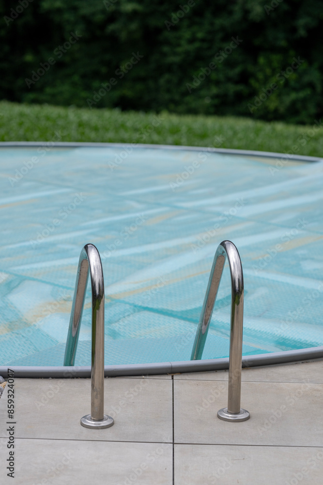 A round swimming pool covered with a foil A round swimming pool covered with a foil