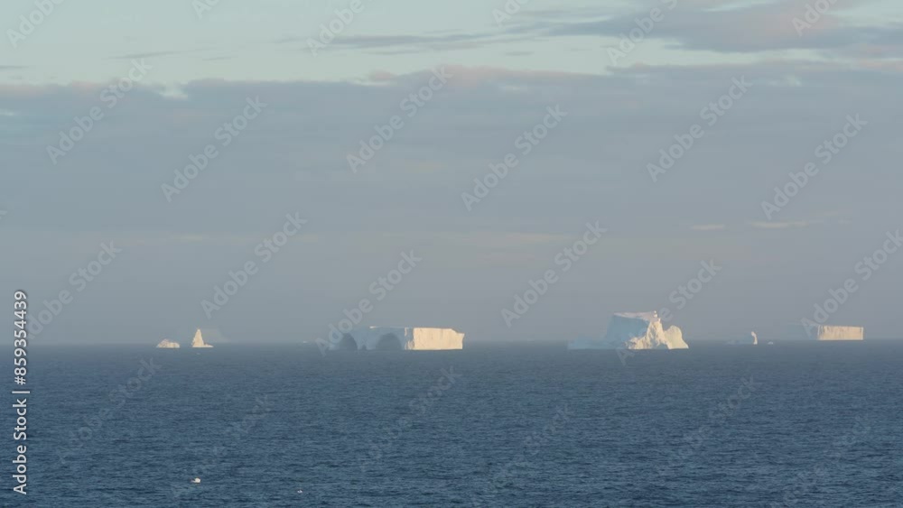 Antarctica Scenic Cruising Icebergs in Ocean Sunset Warm Light in Distance Blue Ocean Vast Open Waters Antarctica Scenic Cruising Icebergs in Ocean Sunset Warm Light in Distance Blue Ocean Vast Open Waters