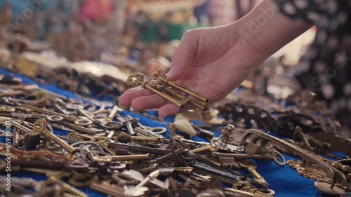 vintage flea market in portugal. lisabon city. girl looks and picks old lost keys, thrifting. woman hands photo