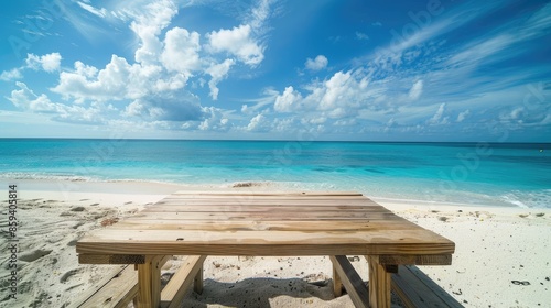 Smooth wooden table placed on a white sandy beach, with the tranquil sea in the background, perfect for showcasing items.