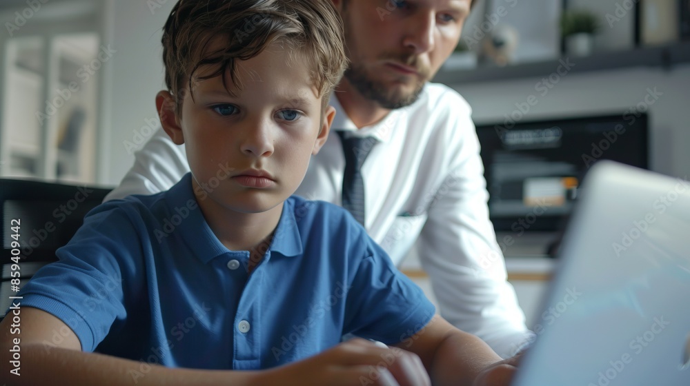 Father and son working together on a laptop. Family teamwork in modern home setting. Office lifestyle with casual and professional elements. Father and son working together on a laptop. Family teamwork in modern home setting. Office lifestyle with casual and professional elements.