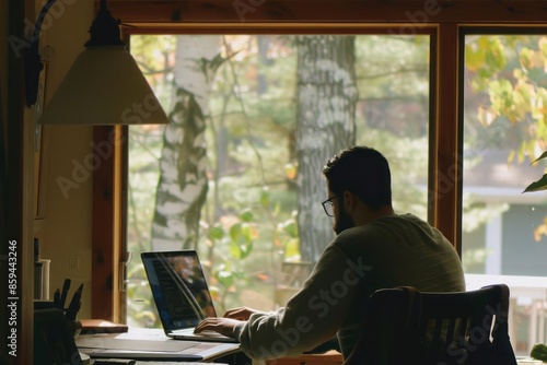 A person working on a laptop in a home office