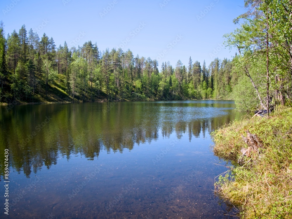 A clear water pond in the forest at Salla, Lapland, Finland. A clear water pond in the forest at Salla, Lapland, Finland.