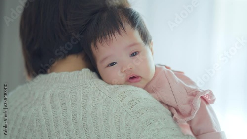 Asian mom mother holding her baby do a burp after breastfeeding at home, Motherhood, care