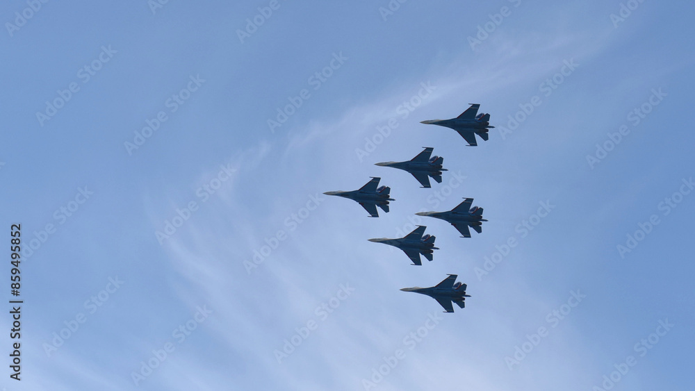 Aviation fighters fly synchronously in the sky. Piloting Mig jets on parade. Aviation fighters fly synchronously in the sky. Piloting Mig jets on parade.