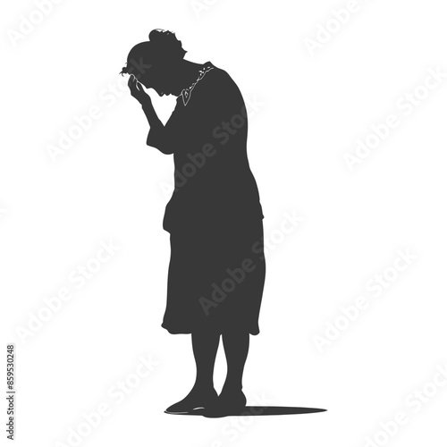 Silhouette of a woman in despair, head in hands, standing alone.