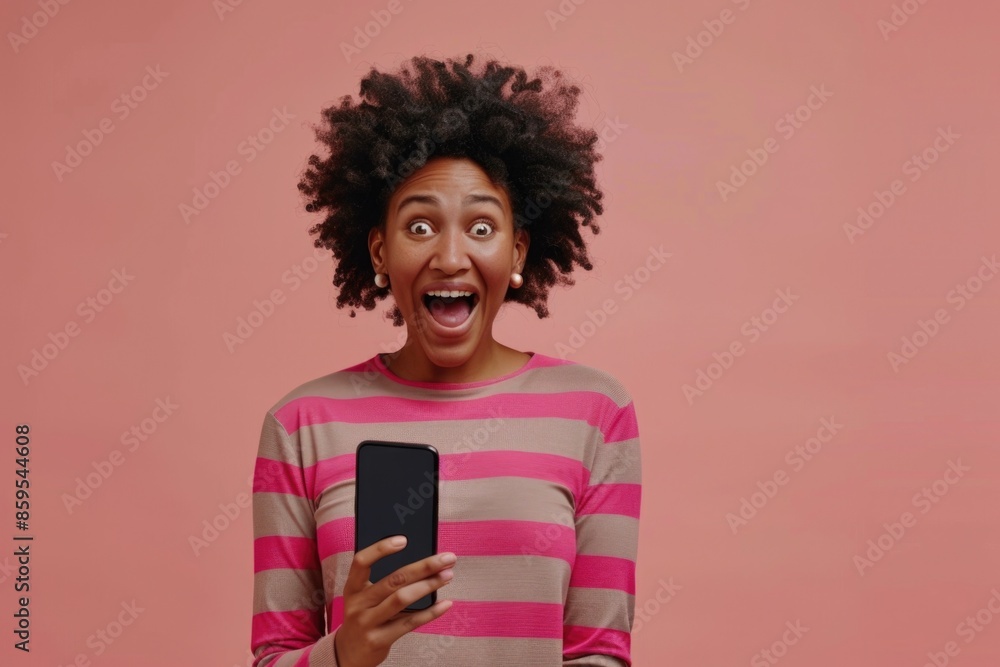 A woman with a surprised expression holds a cell phone, suitable for various technology or human reaction themes A woman with a surprised expression holds a cell phone, suitable for various technology or human reaction themes