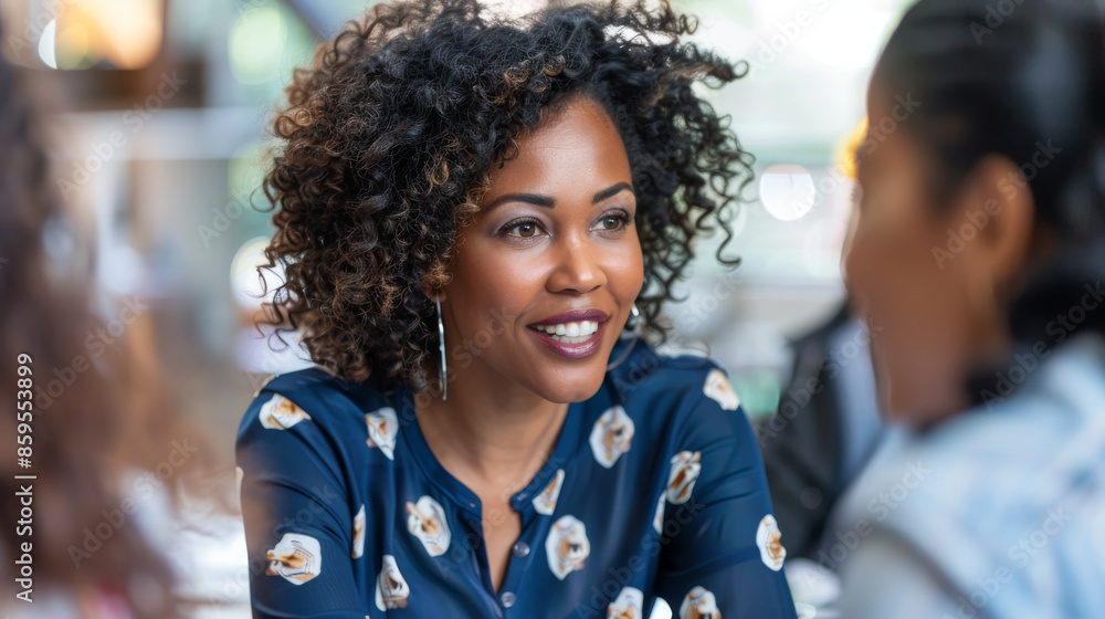 A woman with curly hair is smiling at the camera A woman with curly hair is smiling at the camera