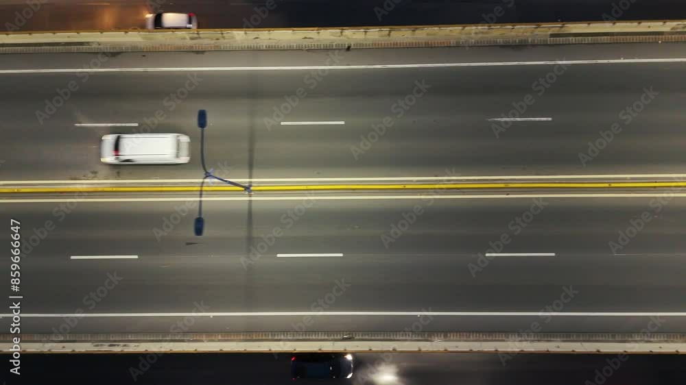 Aerial top view of many cars and trucks driving on asphalt multi level expressway at night illuminated by street lights Aerial top view of many cars and trucks driving on asphalt multi level expressway at night illuminated by street lights