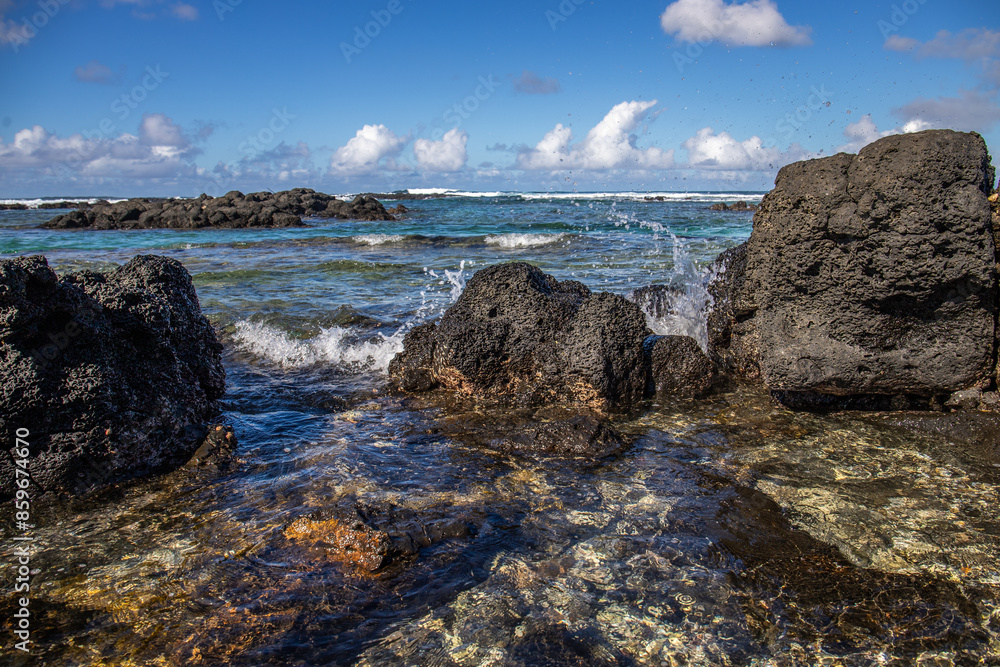 Nice beach in the day. Lava rocks alternate with white fine sandy beach. Coastal landscape of an island in the Indian Ocean, Out of the blue, Trou d’Eau Douce, Mauritius, Africa Nice beach in the day. Lava rocks alternate with white fine sandy beach. Coastal landscape of an island in the Indian Ocean, Out of the blue, Trou d’Eau Douce, Mauritius, Africa