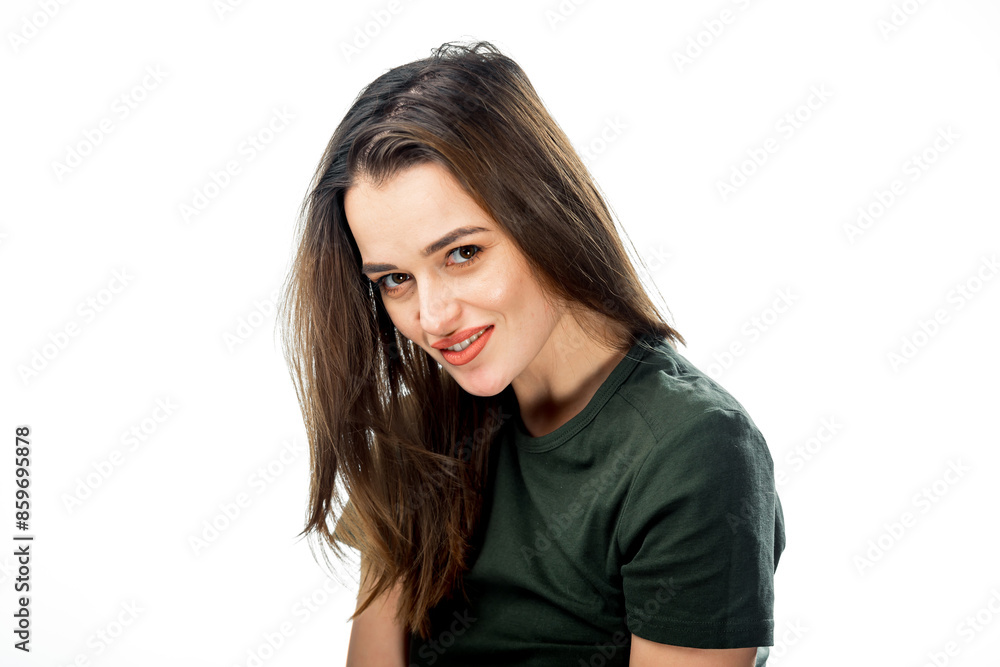 Woman With Brown Hair Smiling. A woman with long brown hair smiles at the camera while wearing a green shirt. Woman With Brown Hair Smiling. A woman with long brown hair smiles at the camera while wearing a green shirt.