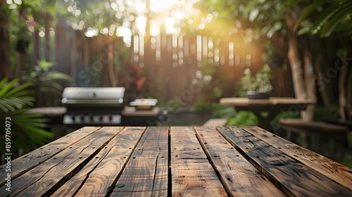 Empty wooden table and blurred bbq in the backyard background, for product display montage