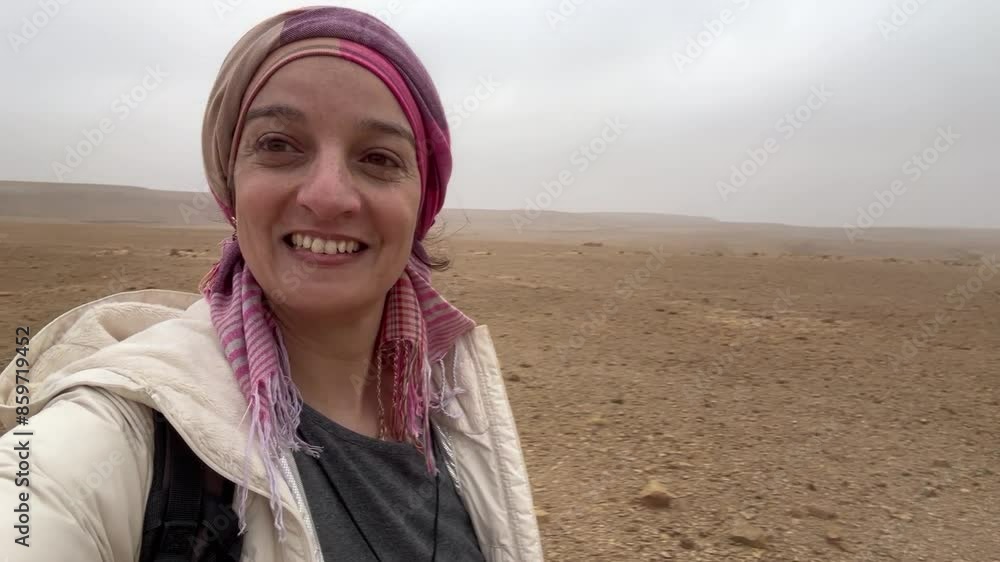 Beautiful young woman taking a 360 video selfie from the top of Tih plateau in the middle of Sinai in Egypt Beautiful young woman taking a 360 video selfie from the top of Tih plateau in the middle of Sinai in Egypt