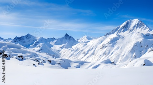 Panoramic view of snow-capped mountains under blue sky