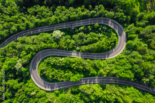 Fototapeta Naklejka Na Ścianę i Meble -  Aerial summer view of a winding mountain road forming an S-shape