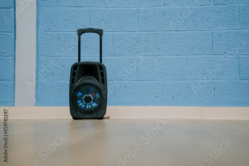 a large bluetooth speaker stands by the wall photo